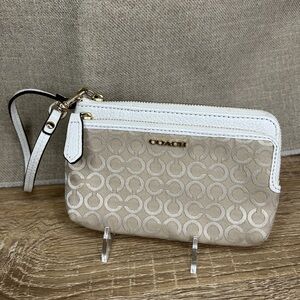 Coach Tan and White Clutch with Signature Pattern